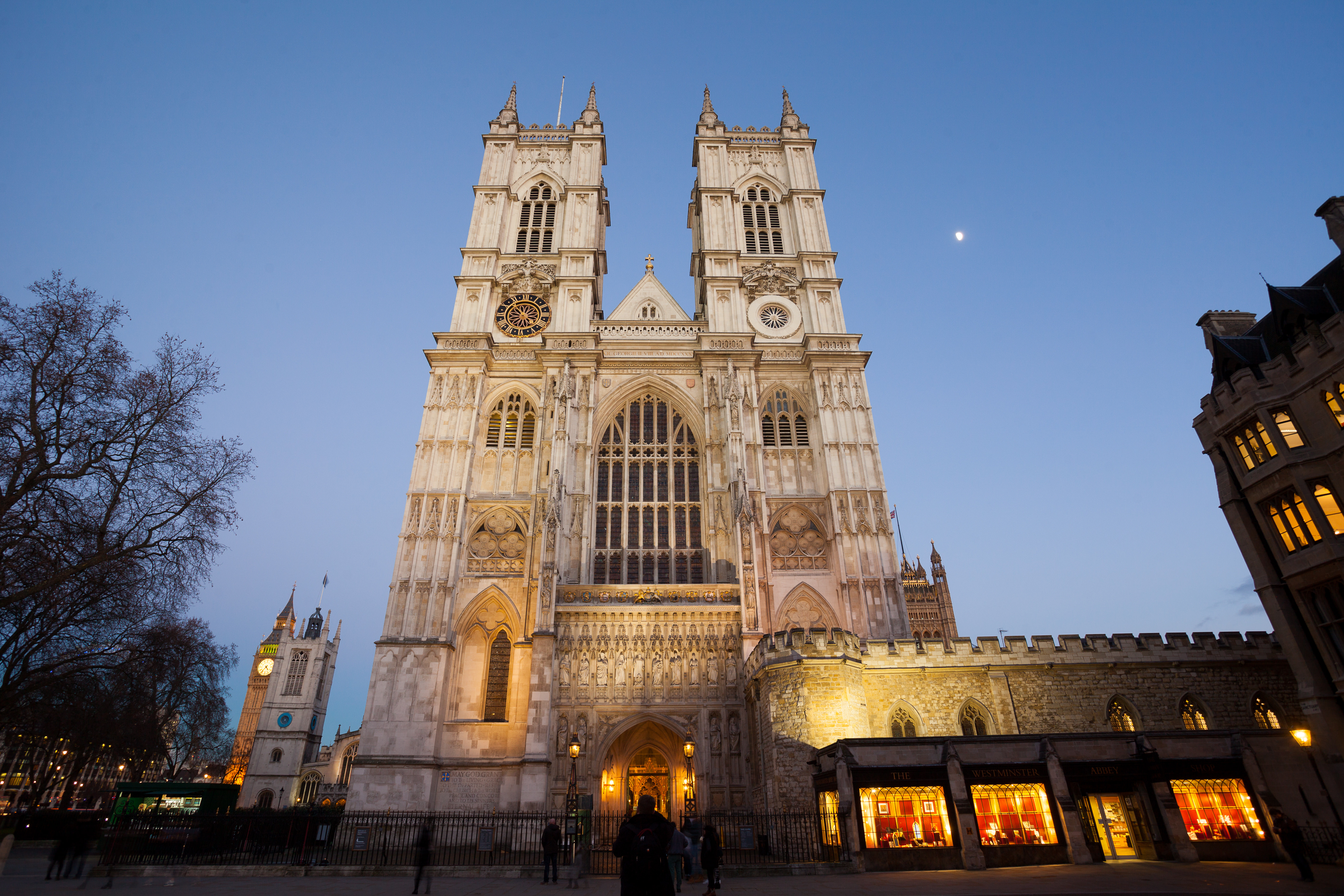 A huge Gothic facade of a cathedral building with two large turrets shot upwards at dusk