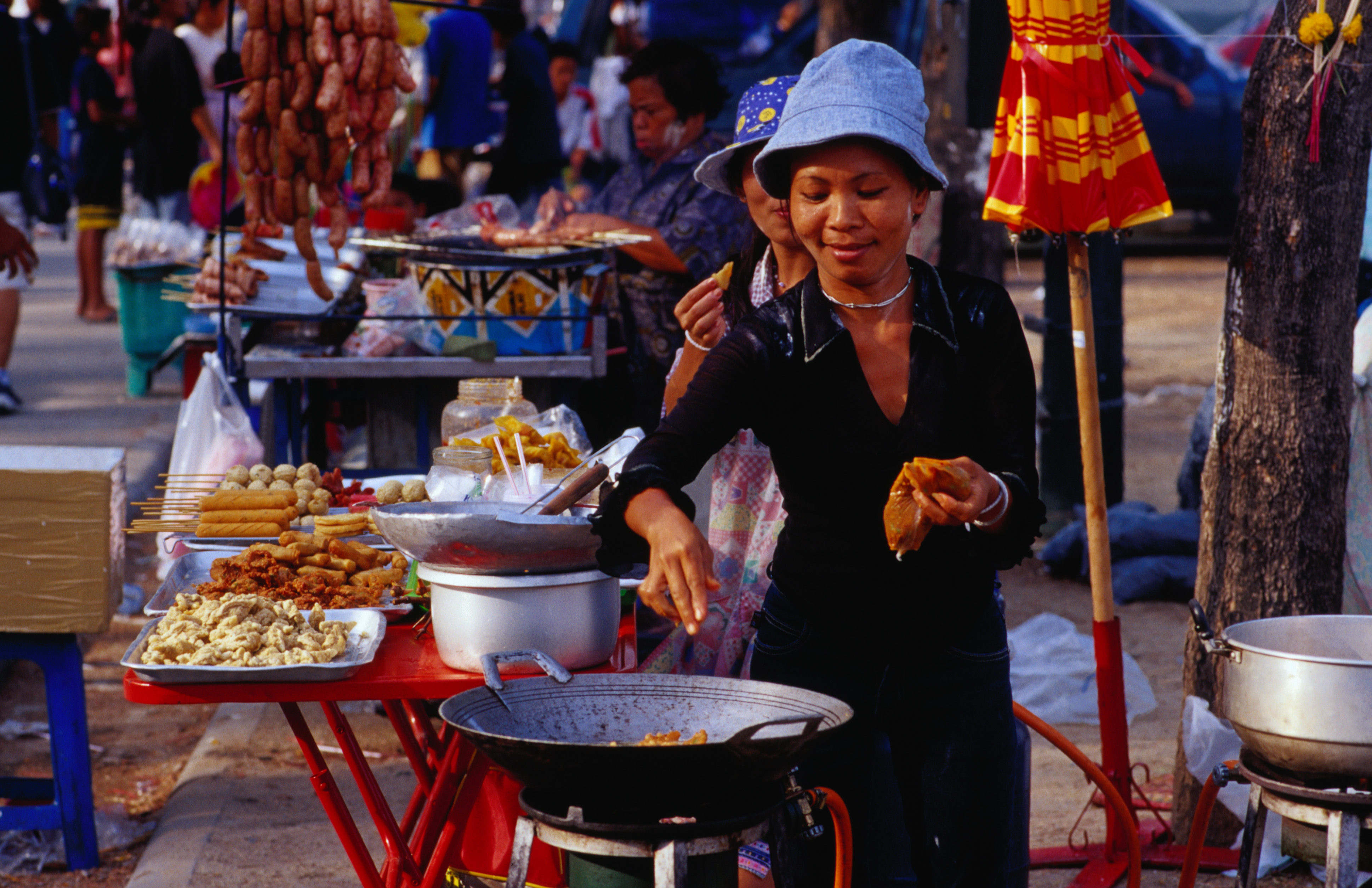 google maps street view tour Vendor cooking at her stall in Sanam Luang gardens in Ratanakosin