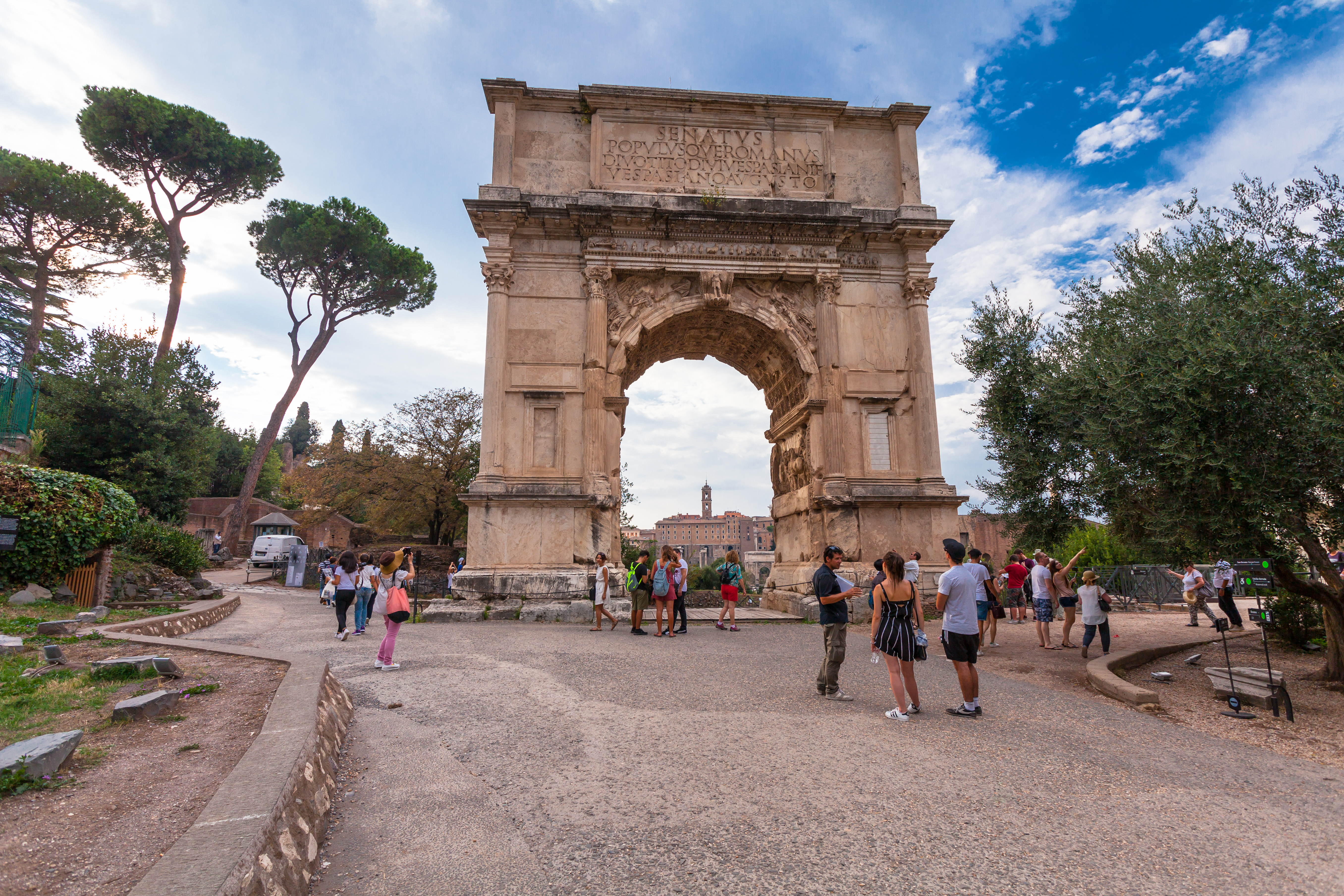 Tourists visit the Arch of Titus in Rome