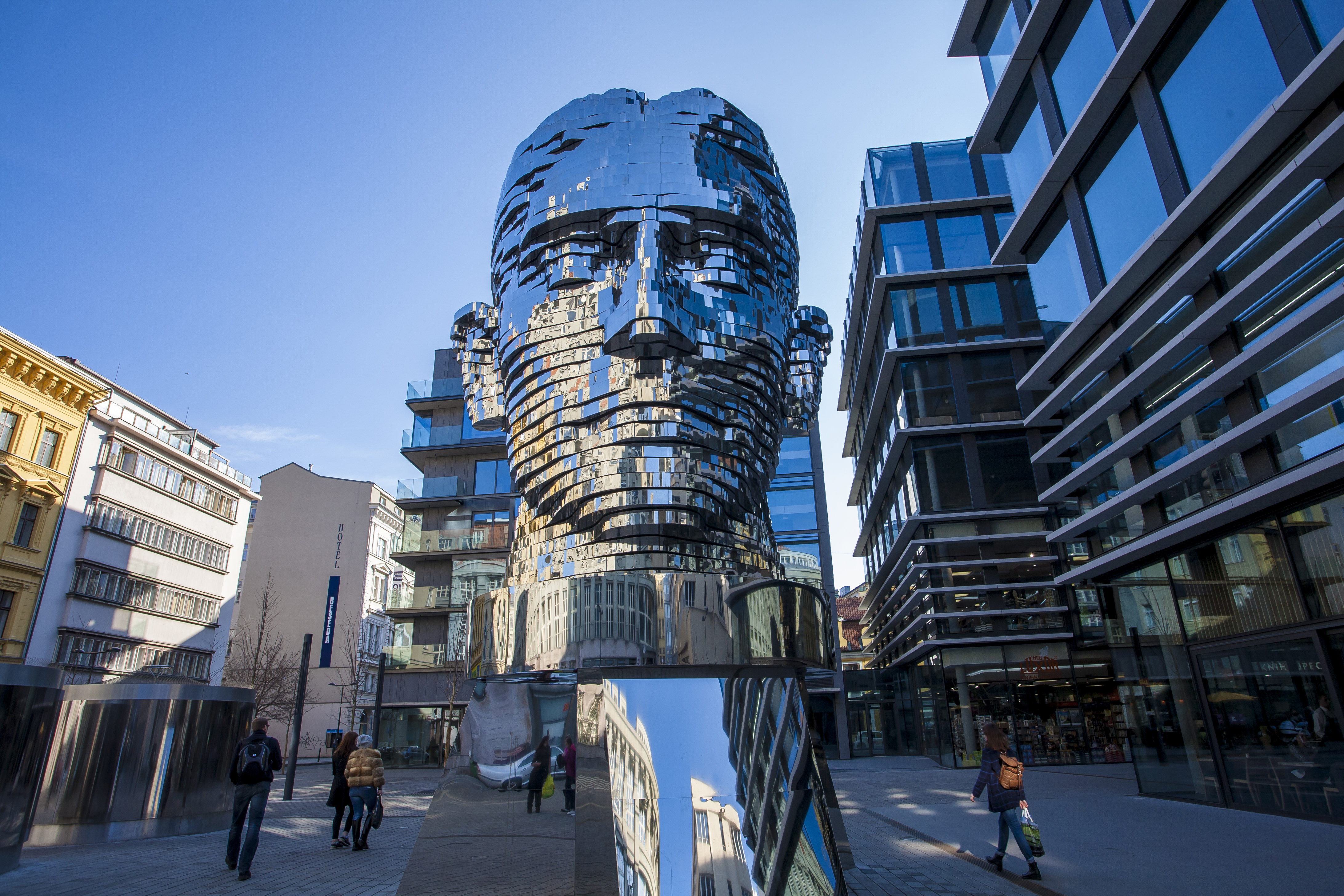 A giant metallic sculpture of the head of author Franz Kafka stands in the centre of a street in Prague.