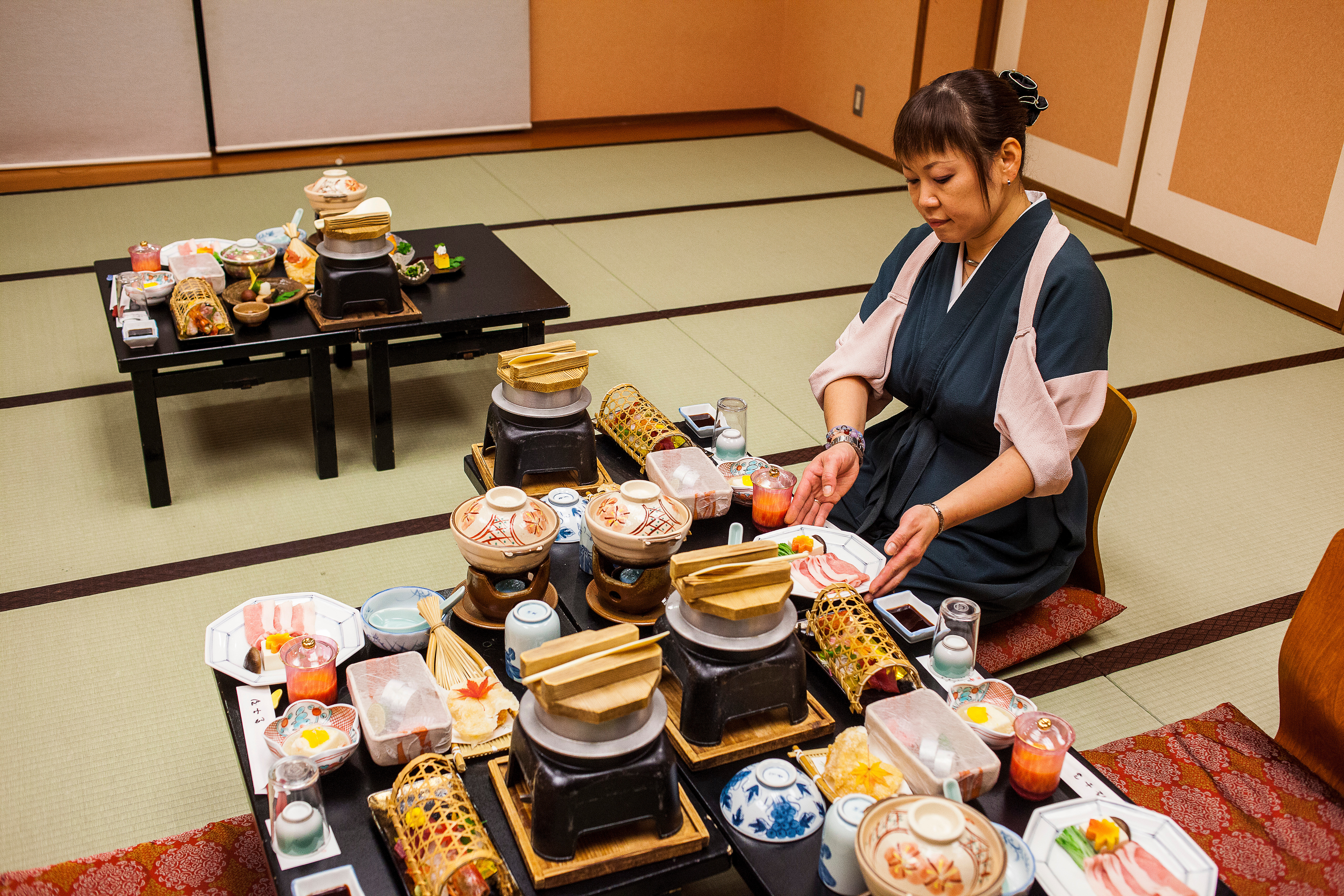 A traditional food at Fujiya Ryokan, Hongucho Kawayu, Tanabe, Wakayama, Honshu, Japan Waitress serving traditional food at Fujiya Ryokan accommodation in Kawayu Onsen on the Kumano Kodo