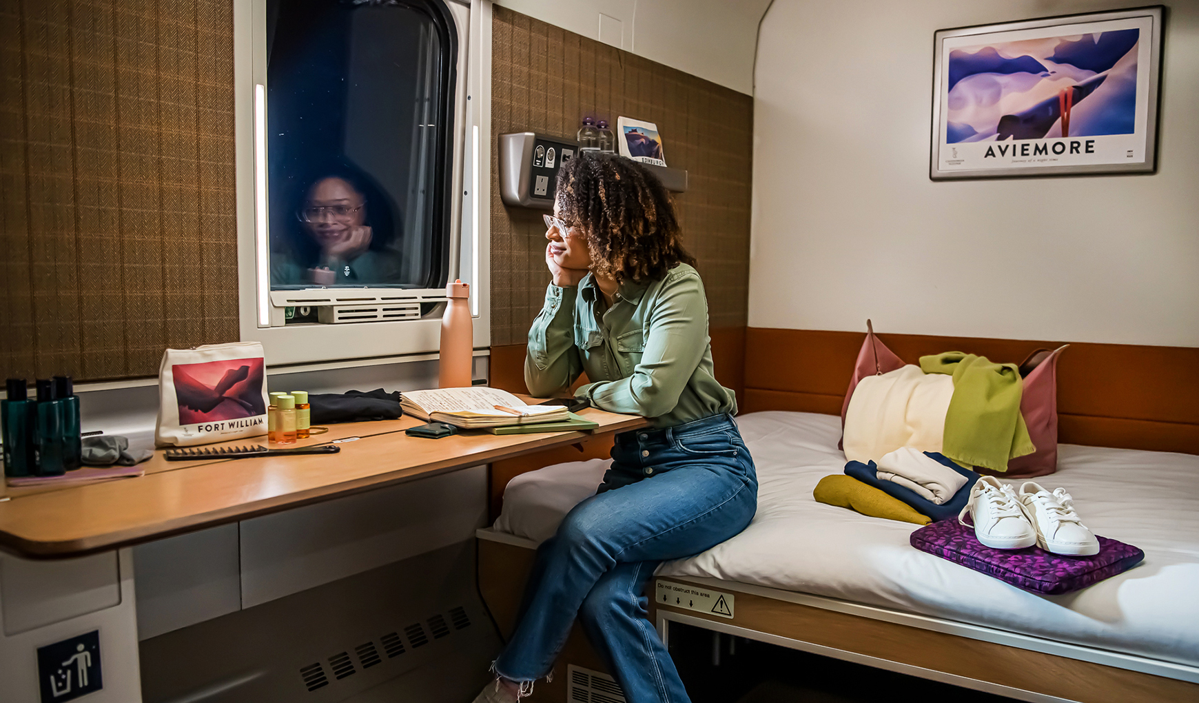A Caledonian Double on the Caledonian Sleeper overnight train A woman looks out the window in a Caledonian Double room aboard the Caledonian Sleeper overnight train between London and Scotland
