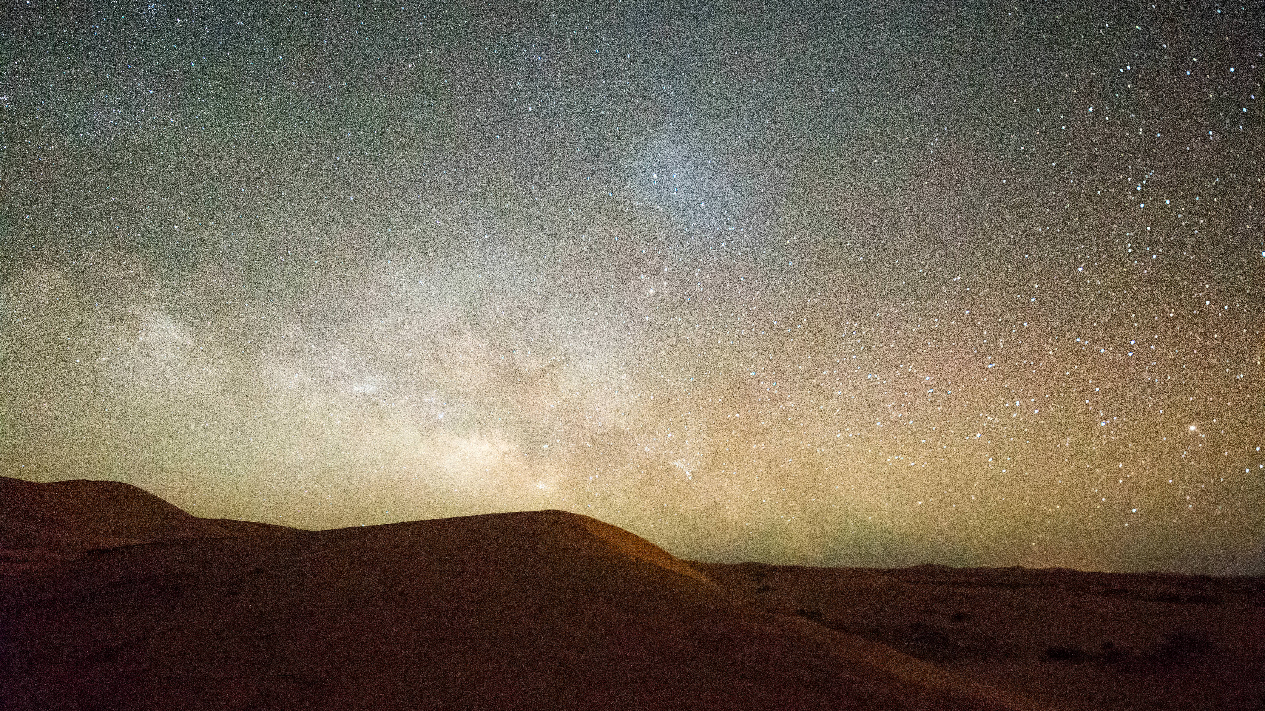 A desert sky at night, filled with stars 